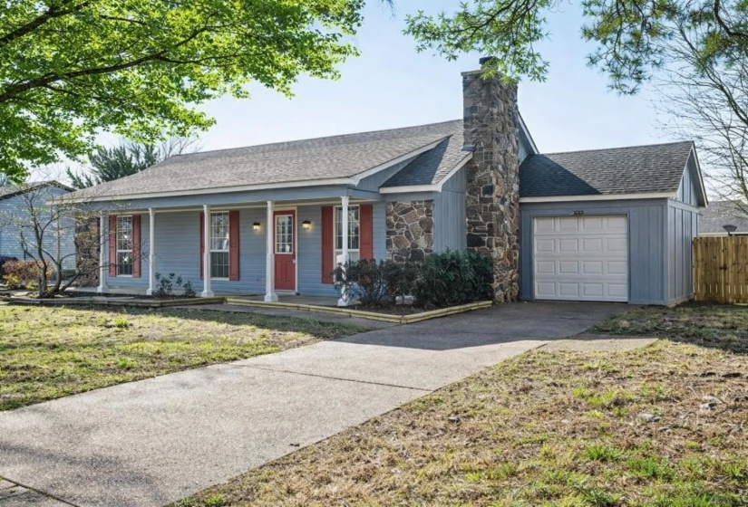 Ranch-style house with a porch, roof with shingles, a garage, and driveway
