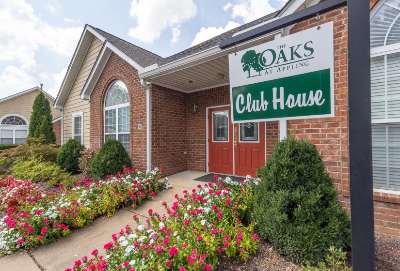 View of exterior entry featuring brick siding and roof with shingles
