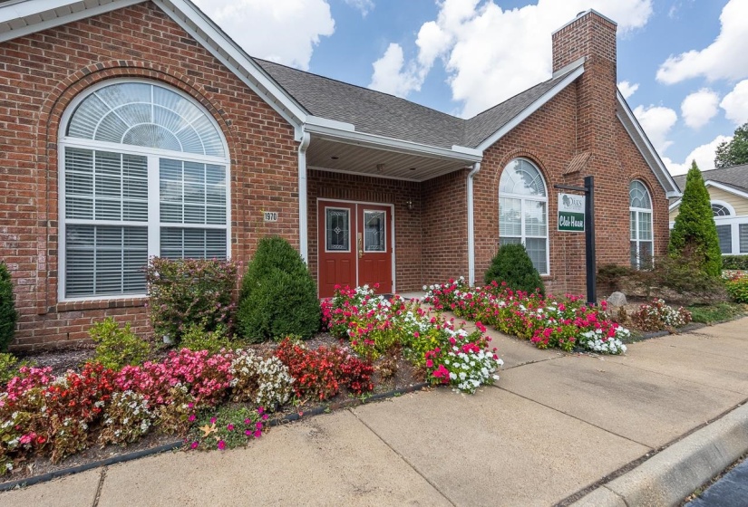Property entrance with brick siding, a shingled roof, and a chimney