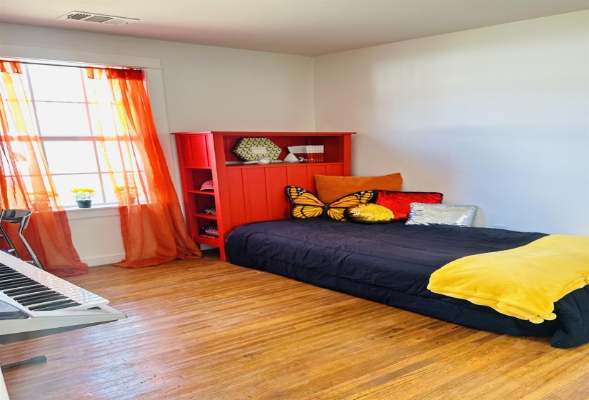 Bedroom featuring hardwood / wood-style flooring and baseboards