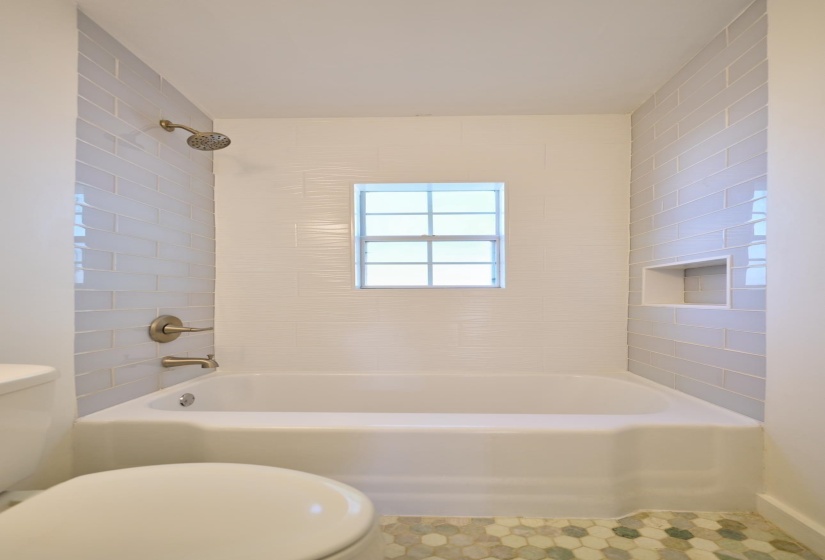 Full bathroom with toilet and tub / shower combination