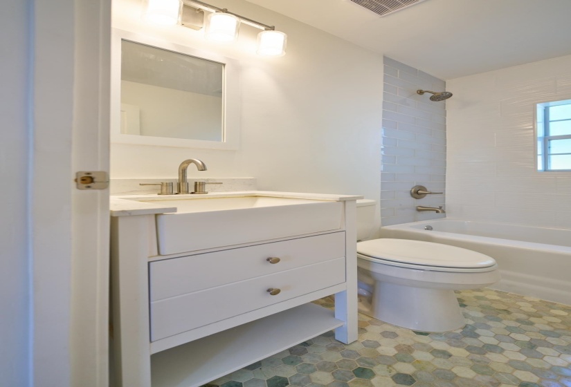 Bathroom featuring vanity and shower / bathtub combination
