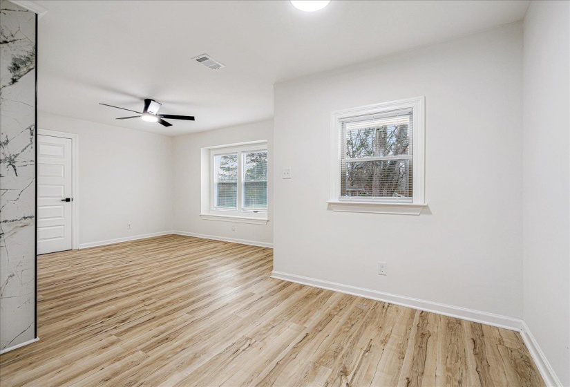 Spare room with light wood-style floors and a ceiling fan