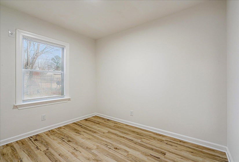 Unfurnished room featuring light wood-style flooring and baseboards
