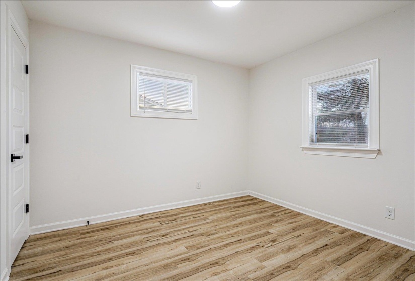 Empty room with light wood-type flooring and baseboards