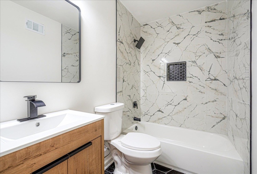 Bathroom featuring vanity and tub / shower combination