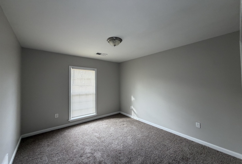 Carpeted empty room featuring baseboards