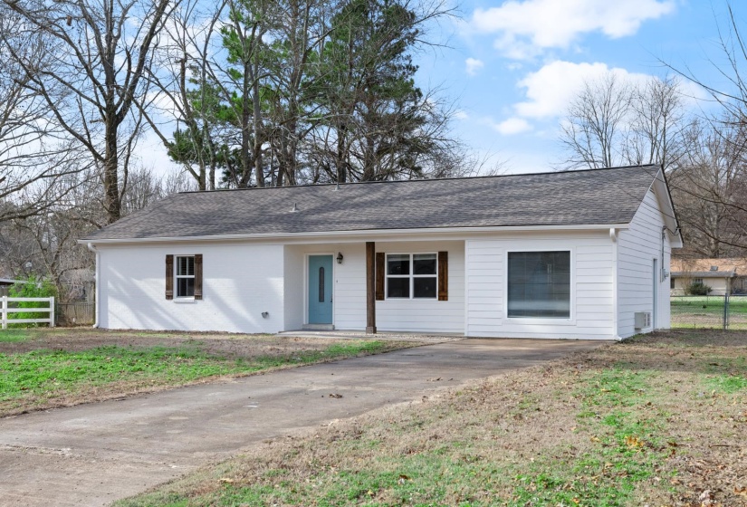 Ranch-style home with covered porch and a shingled roof
