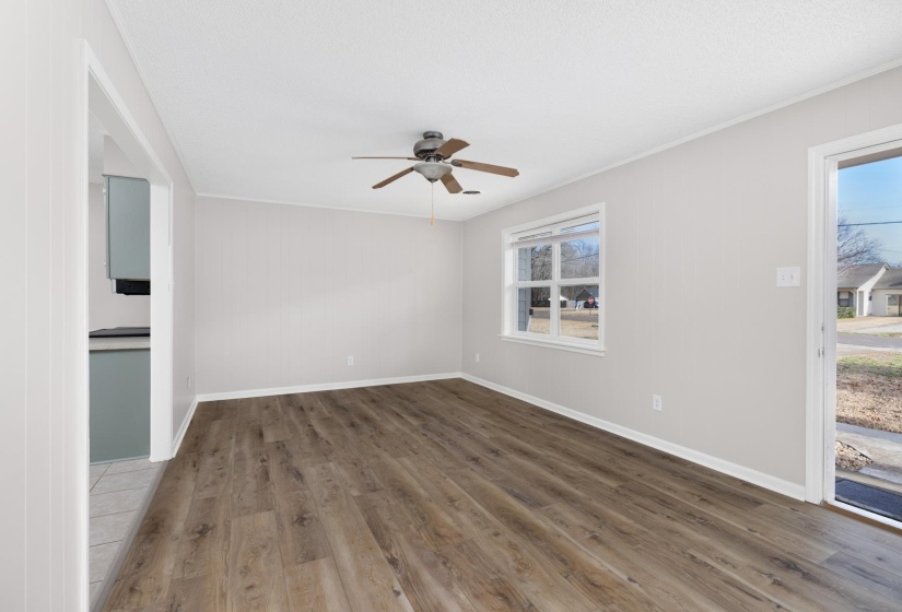 Unfurnished room with wood finished floors and a ceiling fan