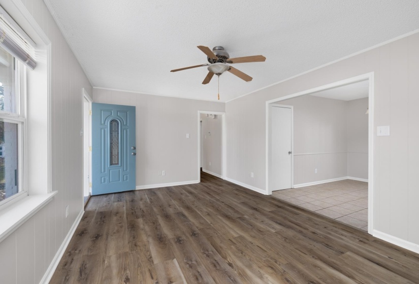 Unfurnished living room with wood finished floors and ceiling fan