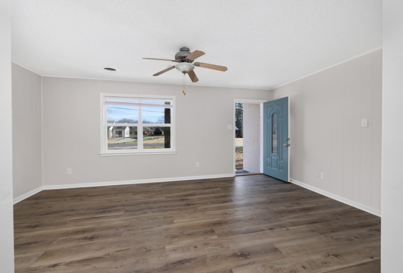 Spare room featuring dark wood finished floors and ceiling fan