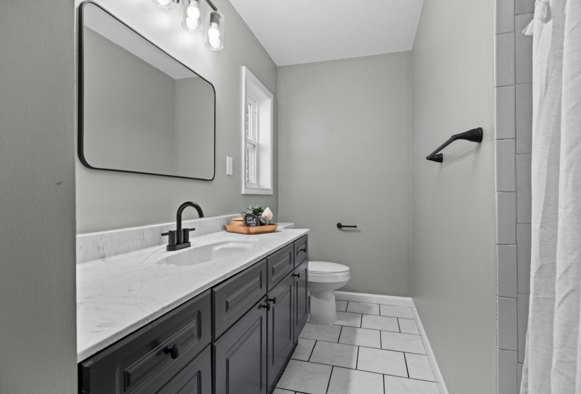 Bathroom featuring vanity and a shower with shower curtain