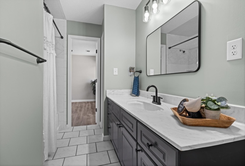 Full bathroom with vanity, a shower with curtain, and light tile patterned floors