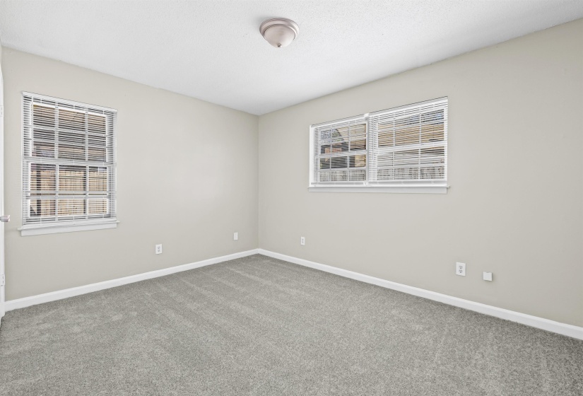 Empty room featuring carpet floors and baseboards