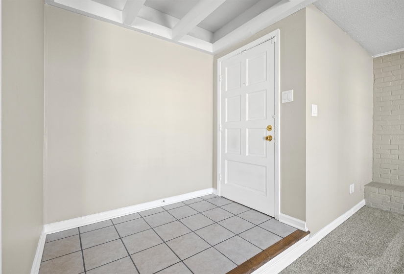Entryway featuring baseboards and tile patterned flooring