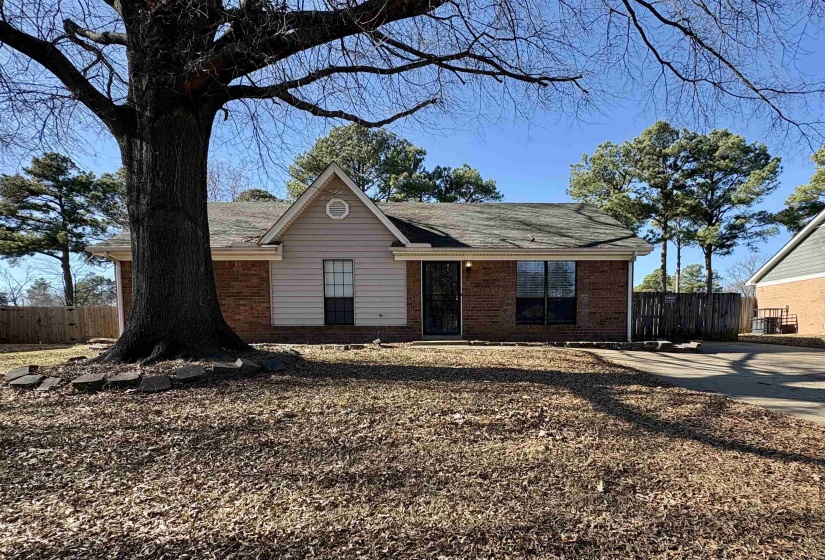 Single story home featuring brick siding and a shingled roof