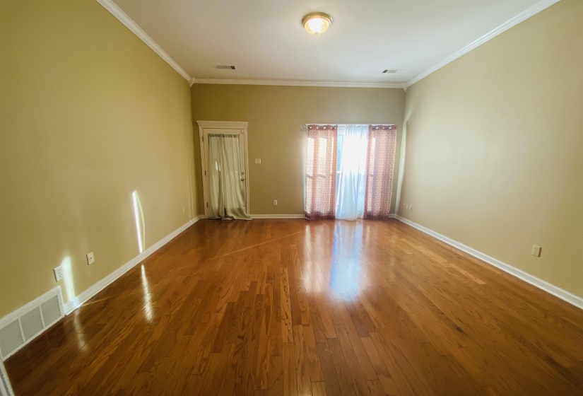 Empty room featuring hardwood / wood-style flooring and crown molding