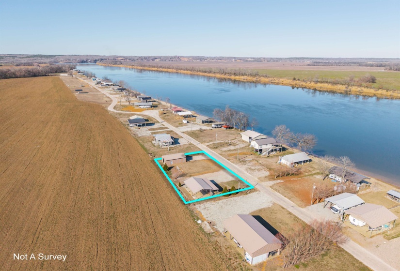 Overview of rural landscape featuring a large body of water and property parcel outlined