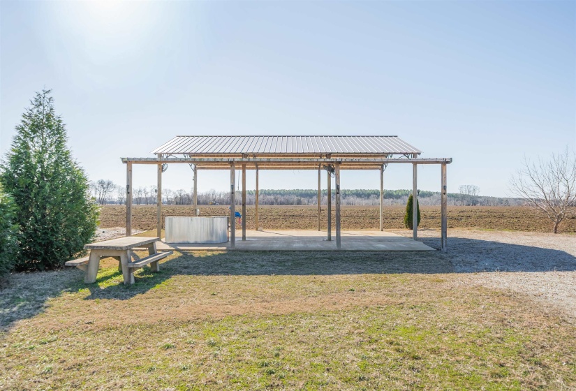 View of grassy yard featuring a patio