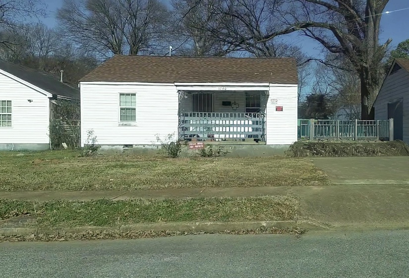 View of front of house featuring roof with shingles and a porch