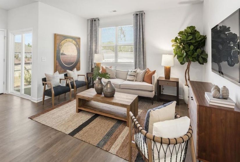 Living area with wood finished floors and baseboards