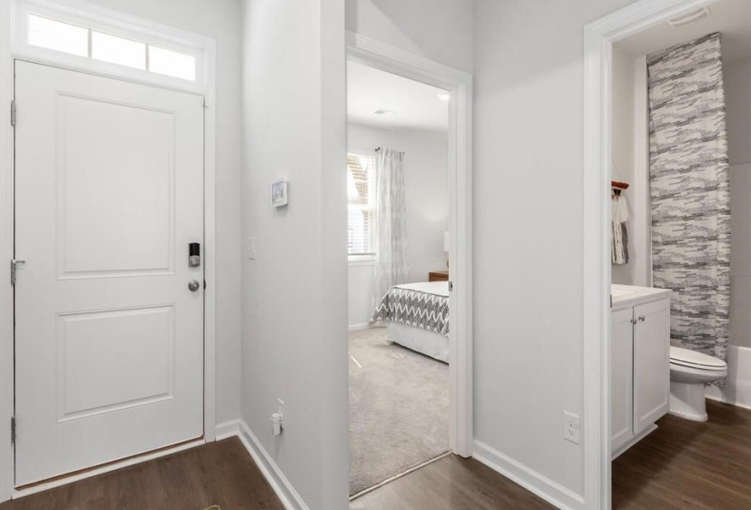 Foyer entrance with dark wood finished floors and baseboards