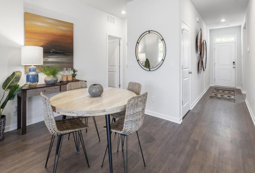 Dining space featuring dark wood-style floors and recessed lighting