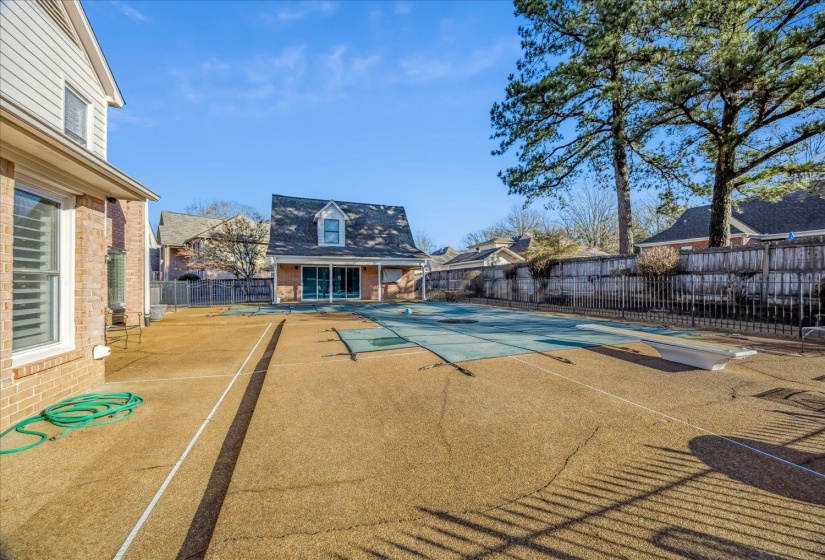 Community pool with a patio area and an outdoor structure