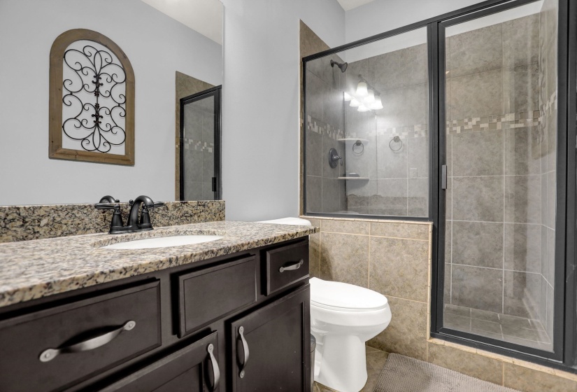 Full bathroom featuring a stall shower and vanity