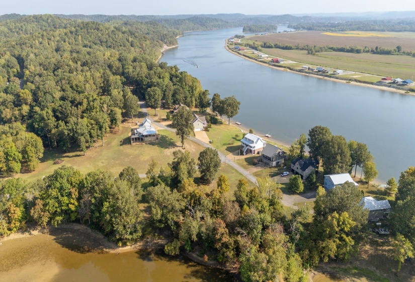 Aerial view of property and surrounding area featuring a large body of water