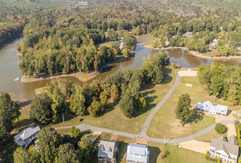 Aerial overview of property's location featuring a large body of water and a heavily wooded area