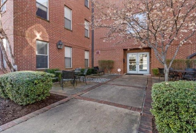 Property entrance with french doors, brick siding, and a patio area