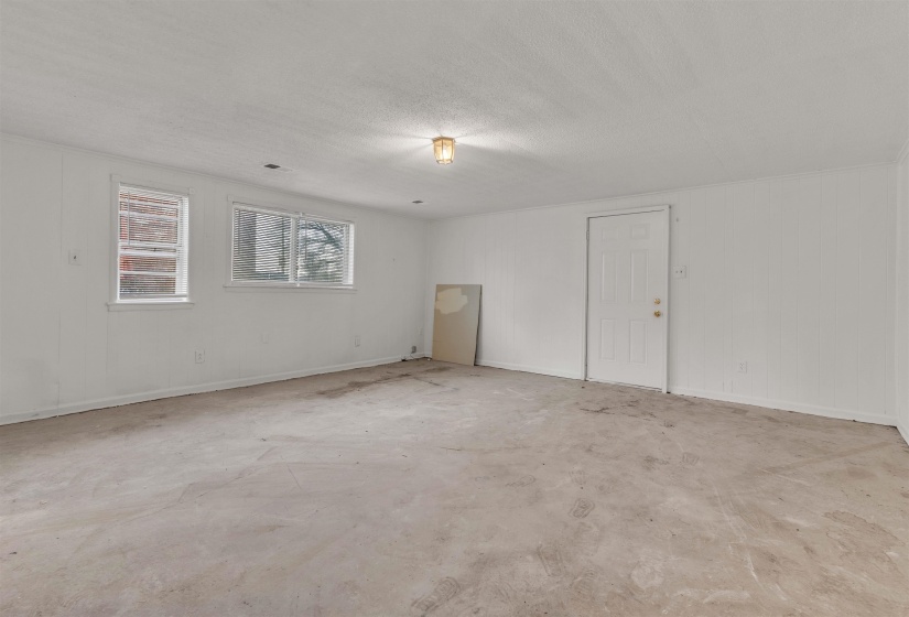 Spare room with concrete flooring and a textured ceiling