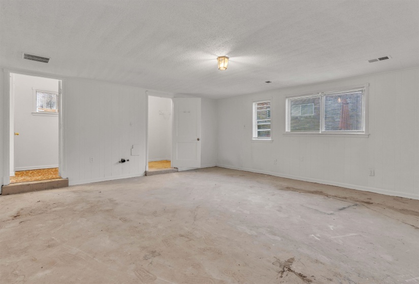 Empty room with baseboards and a textured ceiling