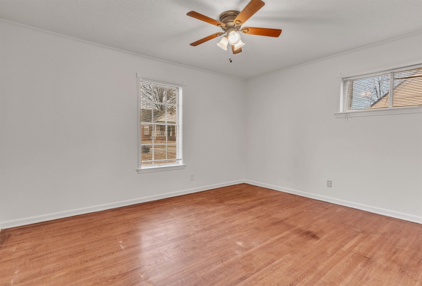 Empty room with light wood finished floors and ceiling fan