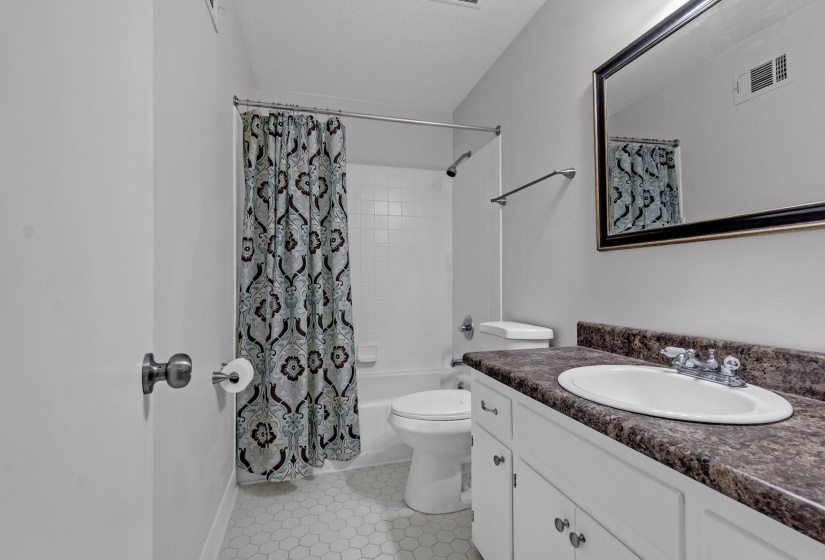 Full bath featuring vanity and shower / bath combination with curtain