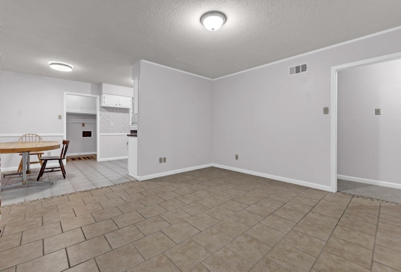 Unfurnished room featuring a textured ceiling and light tile patterned floors