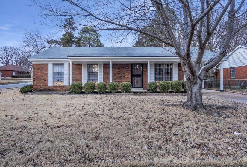 Ranch-style home with a porch and brick siding