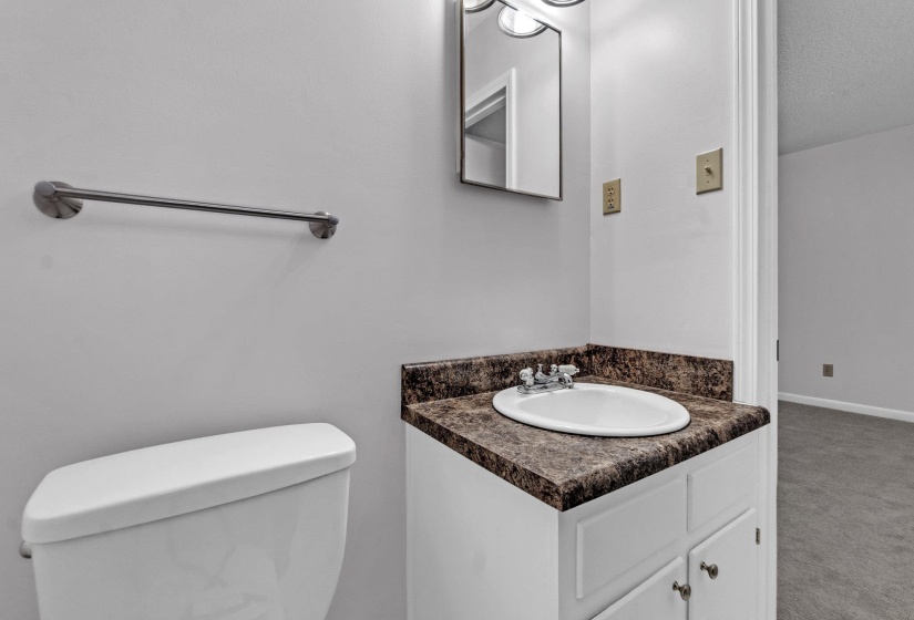 Bathroom with vanity and carpet floors
