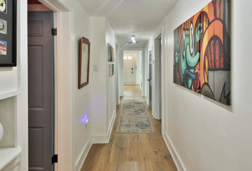 Corridor with baseboards and light wood finished floors