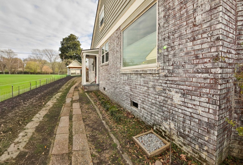 View of home's exterior featuring brick siding and crawl space
