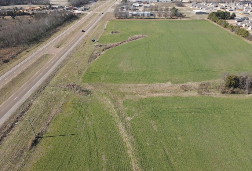 Aerial view of sparsely populated area with large plots for crops