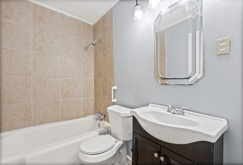 Full bath featuring washtub / shower combination and vanity