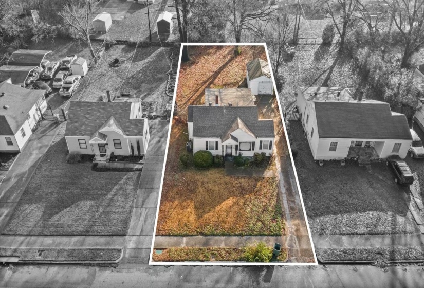 Aerial view of residential area featuring property boundaries highlighted