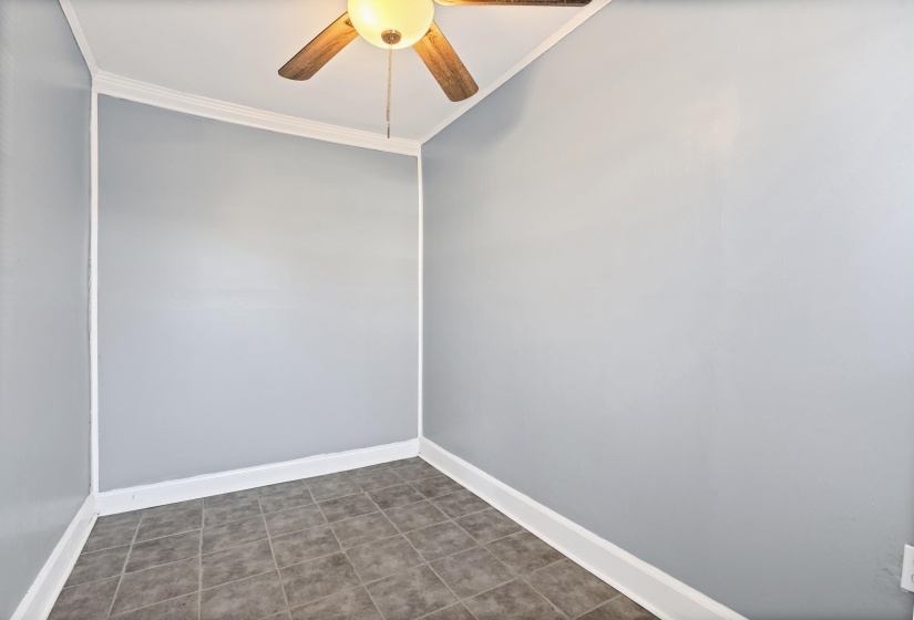 Spare room with crown molding and ceiling fan