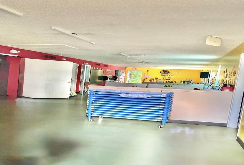 Miscellaneous room with a textured ceiling and attic access