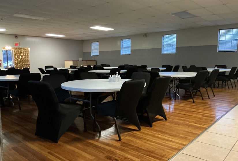 Dining room with a drop ceiling and light wood-type flooring