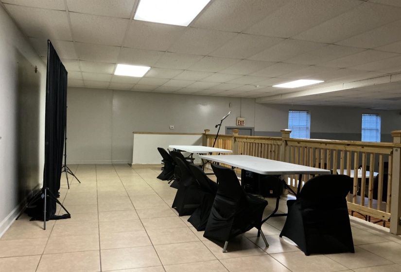Dining space with a drop ceiling and light tile patterned floors