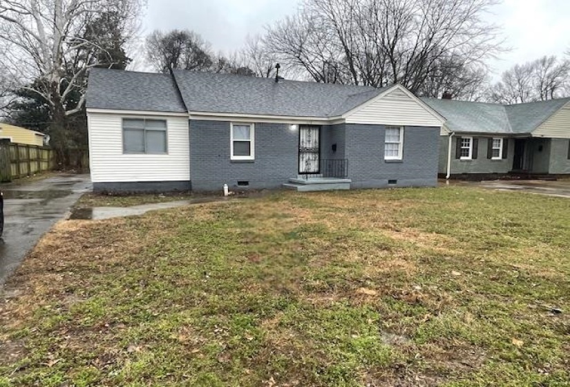 View of front of home featuring crawl space, brick siding, driveway, and a shingled roof