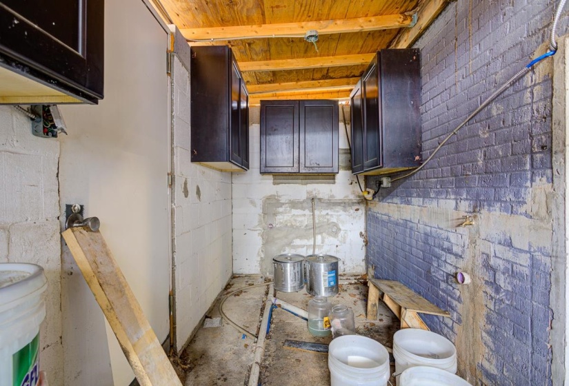 Half bathroom featuring brick wall and toilet